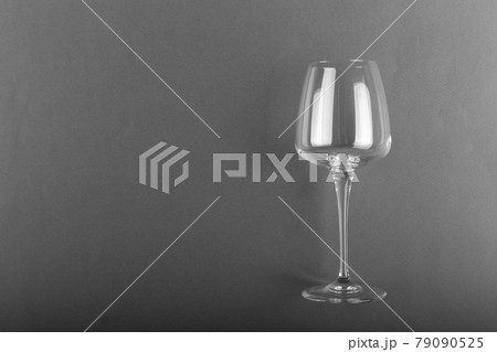 Empty glass of wine on a gray background. 79090525