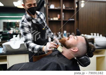 Man client visiting haidresser in barber shop, coronavirus and new normal concept. 79091382