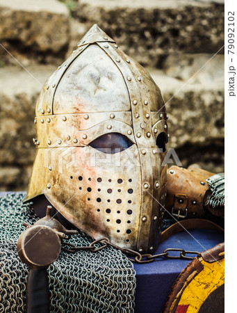 Protective helmet with a visor on medieval knight 79092102