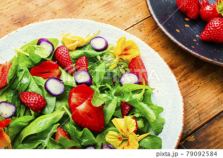 Summer salad with berries and herbs 79092584