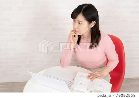 株やFXのトレードを勉強する女性 79092958