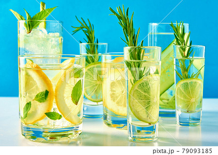 Drink with lime and rosemary on blue background 79093185