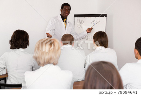 Smiling African American male professor giving presentation for medics Smiling African American male professor giving presentation for medics 79094641