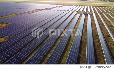Aerial drone view flight over solar power station panels. 79095282