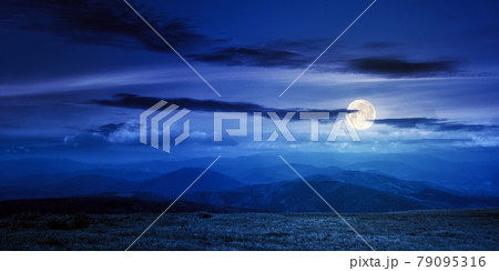 mountain meadow at night. beautiful landscape with clouds above horizon in full moon light. wonderful nature background mountain meadow at night. beautiful landscape with clouds above horizon in full moon light. wonderful nature background 79095316