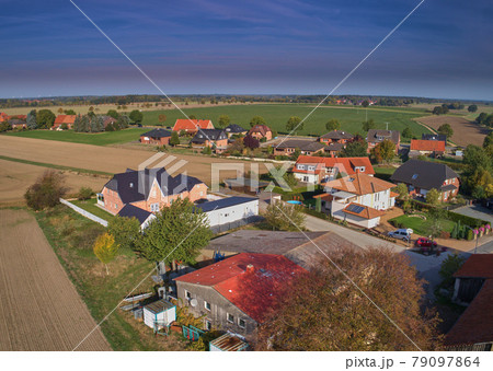 Aerial view of the edge of a settlement with a large shed Aerial view of the edge of a settlement with a large shed 79097864