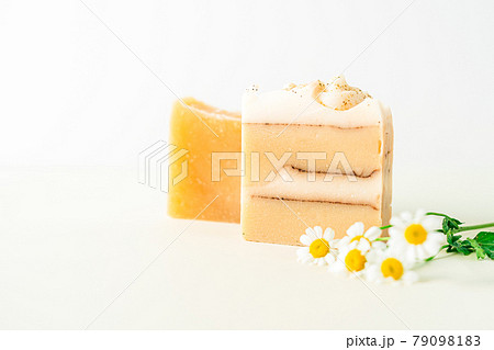Homemade herbal Soap with chamomile Flowers on white marble background. Zero waste, natural organic bathroom cosmetics. Plastic free life. Ecological skin care, body treatment concept. Homemade herbal Soap with chamomile Flowers on white marble background. Zero waste, natural organic bathroom cosmetics. Plastic free life. Ecological skin care, body treatment concept. 79098183