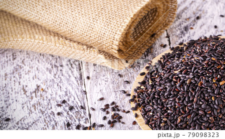 Black rice on old wooden table. Selective focus 79098323