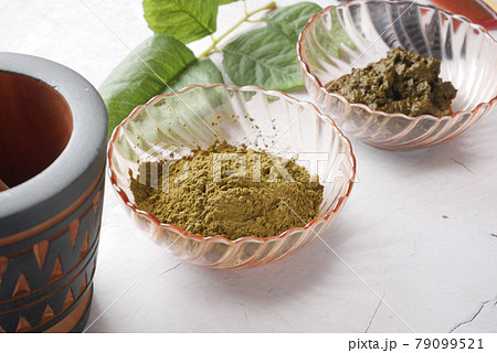 The wooden bowl with rehydrated henna on table The wooden bowl with rehydrated henna on table 79099521