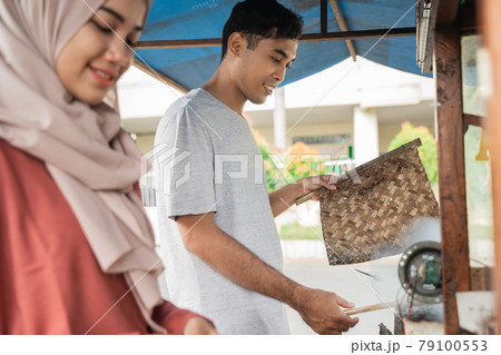 man and woman street food seller 79100553