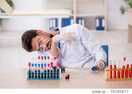 Young male biochemist testing blood samples in pandemic concept Young male biochemist testing blood samples in pandemic concept 79100677