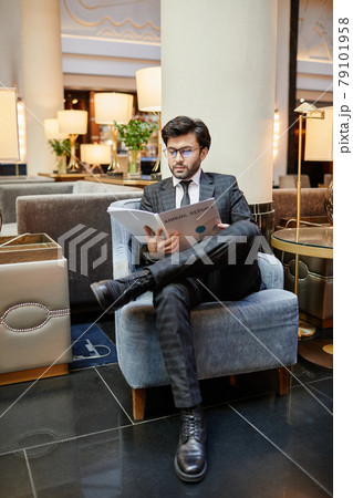 Businessman Relaxing in Hotel Lobby Businessman Relaxing in Hotel Lobby 79101958
