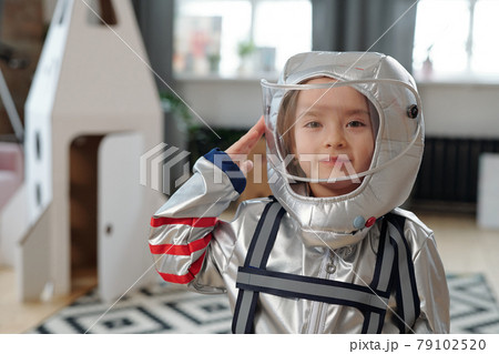 Cute little girl in space-suit standing in living-room Cute little girl in space-suit standing in living-room 79102520