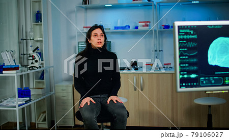 Stressed patient sitting in neurological lab waiting for medical researcher 79106027