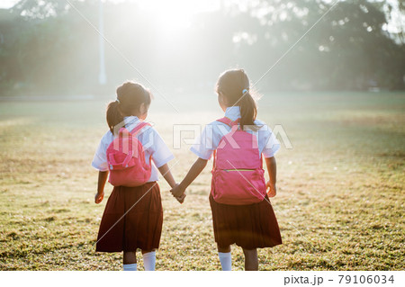 two girl friend primary school student walking together two girl friend primary school student walking together 79106034