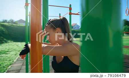 Young woman posing at sports ground. Young woman posing at sports ground. 79106479