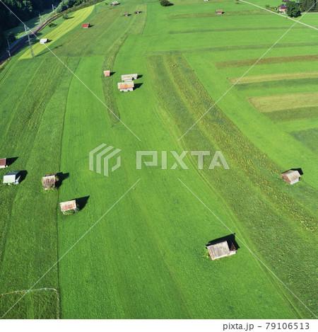 Aerial photo, of a meadow and pasture in Bavaria at the edge of the Alps with sheds and barns Aerial photo, of a meadow and pasture in Bavaria at the edge of the Alps with sheds and barns 79106513
