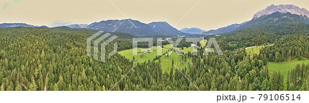 Panorama of a forest and a valley with meadows and pastures in front of the mountains of the Alps, composed of several aerial photos, high resolution Panorama of a forest and a valley with meadows and pastures in front of the mountains of the Alps, composed of several aerial photos, high resolution 79106514