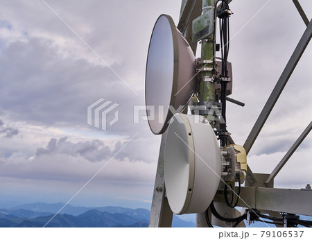 Satellite dishes on a mast on a high mountain in the Alps 79106537