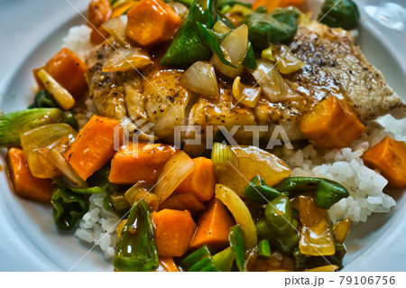 Sweet-sour vegetables in Chinese style with a light starch flour sauce on steamed cod on rice Sweet-sour vegetables in Chinese style with a light starch flour sauce on steamed cod on rice 79106756