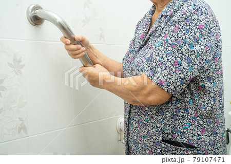 Asian senior or elderly old lady woman patient use slope walkway handle security with help support assistant in nursing hospital ward; healthy strong medical concept. 79107471