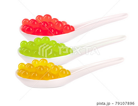 Tapioca pearls for bubble tea isolated on white background. Mix tapioca fruit pearls in spoon. Tapioca pearls for bubble tea isolated on white background. Mix tapioca fruit pearls in spoon. 79107896