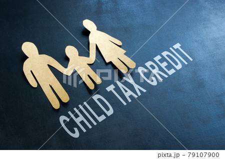 Paper family and words child tax credit on the blackboard. 79107900