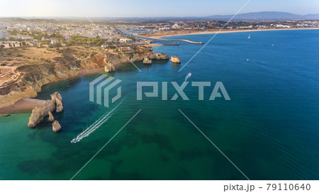Aerial view of the beautiful paradise beaches of Camilo and Dona Anna, Lagos area. Tourist boats and ships entertain tourists on summer vacations. Aerial view of the beautiful paradise beaches of Camilo and Dona Anna, Lagos area. Tourist boats and ships entertain tourists on summer vacations. 79110640