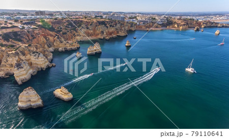 Aerial view of the beautiful paradise beaches of Camilo and Dona Anna, Lagos area. Tourist boats and ships entertain tourists on summer vacations. Aerial view of the beautiful paradise beaches of Camilo and Dona Anna, Lagos area. Tourist boats and ships entertain tourists on summer vacations. 79110641