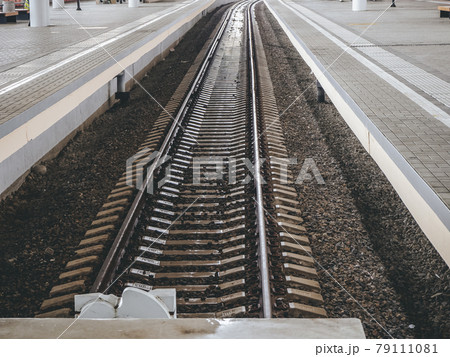 View of the railway rails and sleepers and high side platforms. Long-distance rails View of the railway rails and sleepers and high side platforms. Long-distance rails 79111081