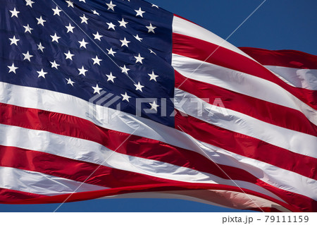 American Flag Waving In Wind Against a Deep Blue Sky. American Flag Waving In Wind Against a Deep Blue Sky. 79111159