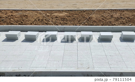 Installation of paving slabs tile on a city street Installation of paving slabs tile on a city street 79111504