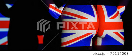 The projection of the flag of the United kingdon on a beautiful large female ass. The projector shines with a flag of the England on a female body. British The projection of the flag of the United kingdon on a beautiful large female ass. The projector shines with a flag of the England on a female body. British 79114003