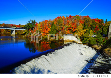 The Falls and Bridge in autumn with colorful trees and the blue sky. The Falls and Bridge in autumn with colorful trees and the blue sky. 79114603
