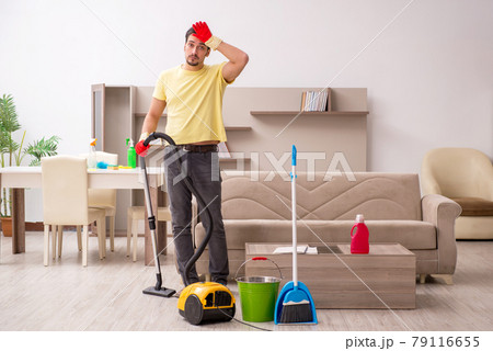 Young male contractor cleaning the house Young male contractor cleaning the house 79116655