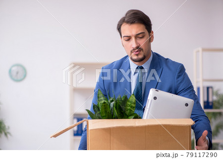 Young male employee in business relocation concept 79117290