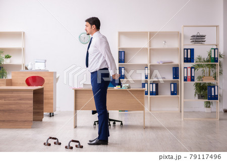 Young male employee doing sport exercises during break Young male employee doing sport exercises during break 79117496