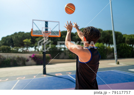 Male Sportsman Playing Basketball Throwing The Stock Photo