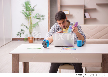 Young male designer working from house 79118505