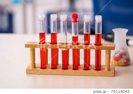 Tubes and pills on the desk in drugs synthesis concept Tubes and pills on the desk in drugs synthesis concept 79119043