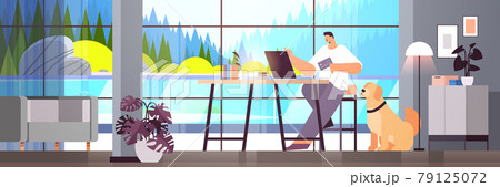 young man with credit card using laptop online shopping concept living room interior horizontal 79125072