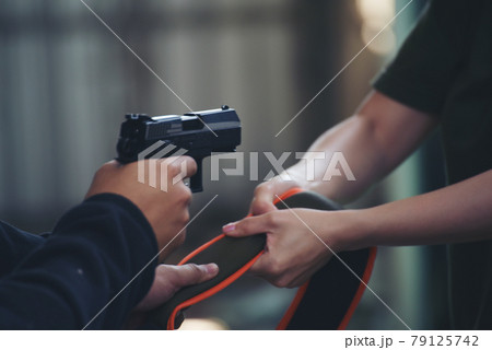 Thief armed man rob woman by gun on street so scared shocked face. Frightened asian woman was rob aggressive by danger bandit man. Robbery thief using gun burglar. Criminal aggression crime concept. Thief armed man rob woman by gun on street so scared shocked face. Frightened asian woman was rob aggressive by danger bandit man. Robbery thief using gun burglar. Criminal aggression crime concept. 79125742
