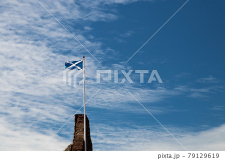 Scottish Saltire Flag Flying Over a Scottish Castle Ruin 79129619