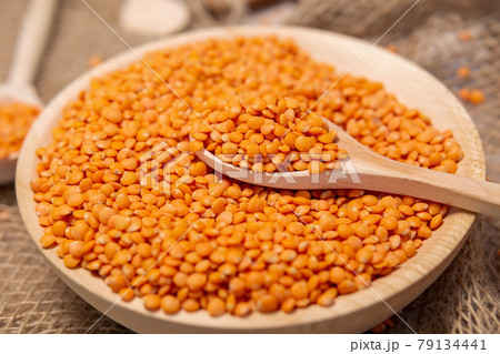 Orange lentils in a wooden bowl. selective focus. Rustic style 79134441