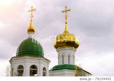 Domes of a religious building. Crosses on the domes of the church. Cathedral with gold domes. 79134442