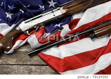 Automatic rifle on USA flag on wooden background Automatic rifle on USA flag on wooden background 79134505