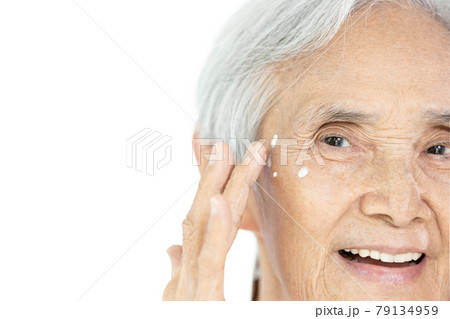 Face of asian old elderly with good health of facial skin,applying anti-aging cream to remove wrinkles and crow's feet on the face,under-eye dark circles with eye cream,healthy skin,skin care concept Face of asian old elderly with good health of facial skin,applying anti-aging cream to remove wrinkles and crow's feet on the face,under-eye dark circles with eye cream,healthy skin,skin care concept 79134959