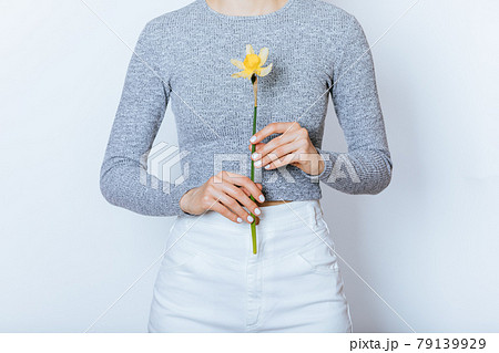 Young woman wearing white high waist jeans and gray crop top long sleeve Young woman wearing white high waist jeans and gray crop top long sleeve 79139929