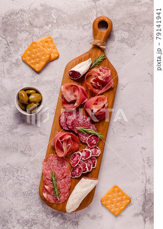 Serving board with a set of different meat snacks. Serving board with a set of different meat snacks. 79141941