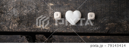 I love you sign spelled on wooden dicer with marble made heart in the middle I love you sign spelled on wooden dicer with marble made heart in the middle 79143414